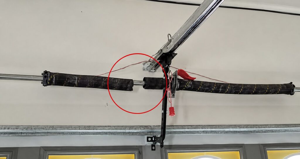 Broken garage door torsion spring with a visible gap in the coil on a residential garage door system in Evanston Illinois