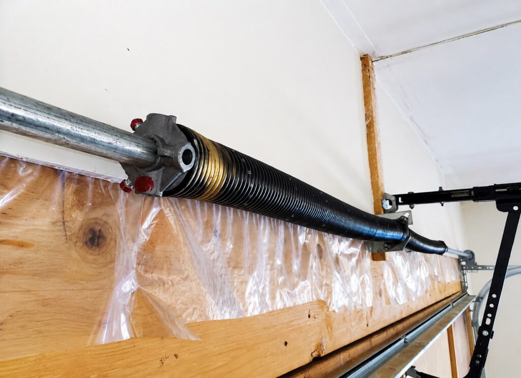 Garage door torsion spring installed above a residential garage door in Evanston Illinois