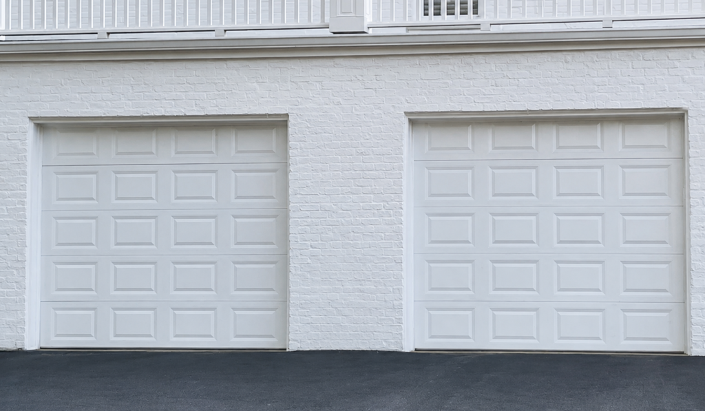 Ceiling-mounted garage door opener unit showing wear and exposed wiring